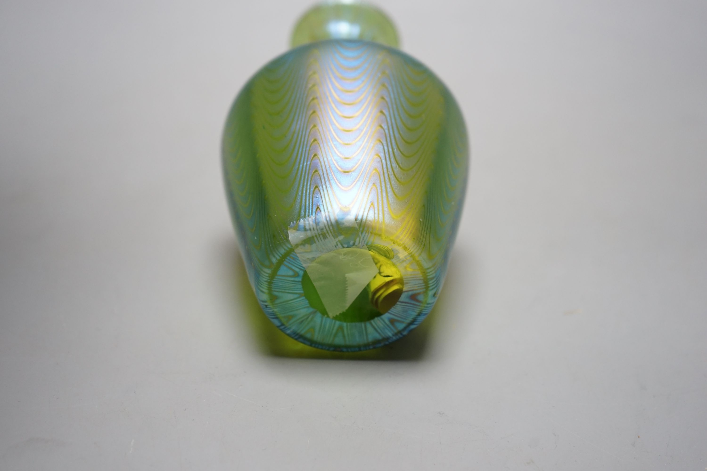 A Loetz style iridescent glass vase, flared narrow neck and bulbous body waved decoration, 14 cms high.